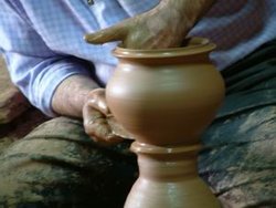 A man shapes pottery as it turns on a wheel. (Cappadocia, Turkey).