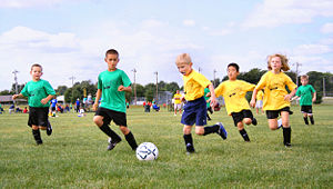 Sport from childhood. Football (soccer) shown above is a team sport, and has social importance.